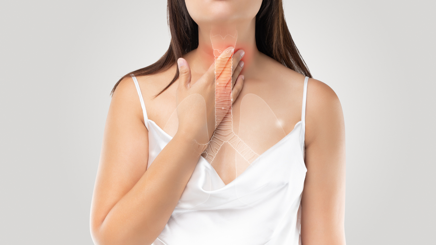 Lady with her hand on her neck showing lump nodes