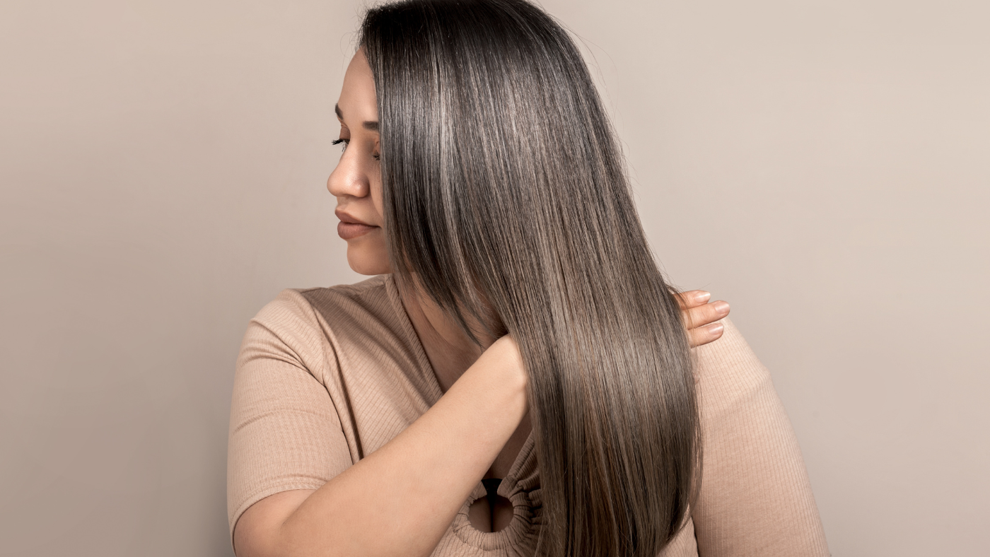 Keratin supplement benefits illustrated by a women showing her long flowing shiny hair
