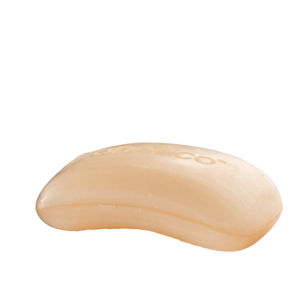 Beige bar of soap on a white background