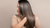 Keratin supplement benefits illustrated by a women showing her long flowing shiny hair