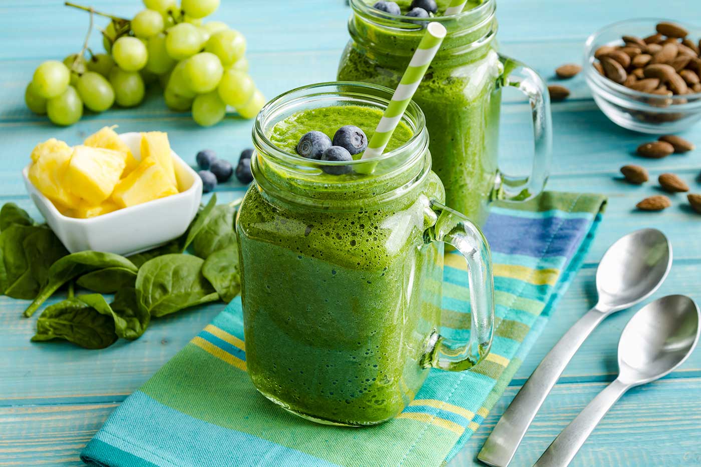 Healthy green collagen smoothie with blueberries on top