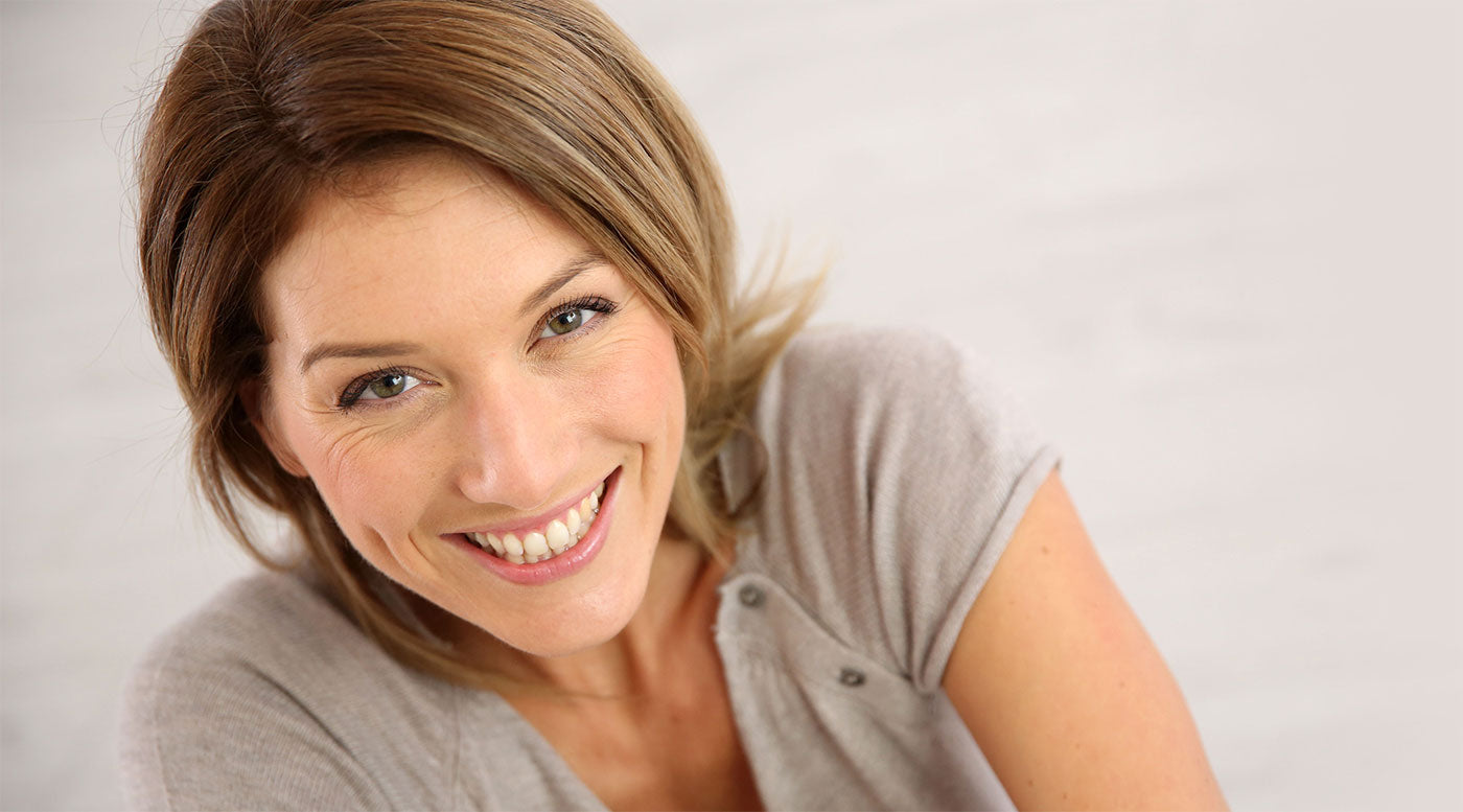 Woman with great mature skin smiling up at the camera 