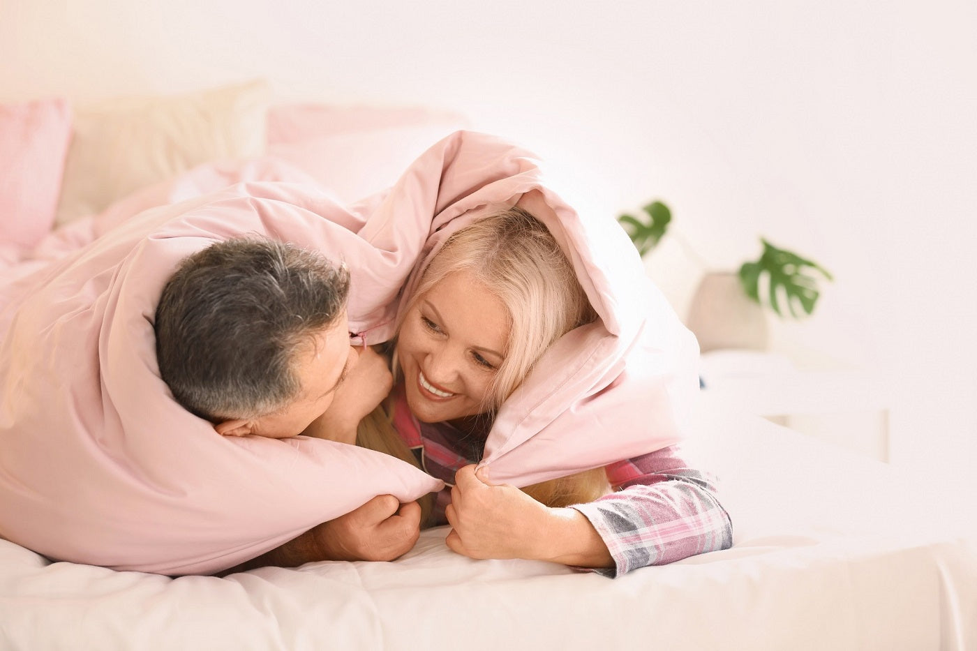 Senior couple under blanket in bed together