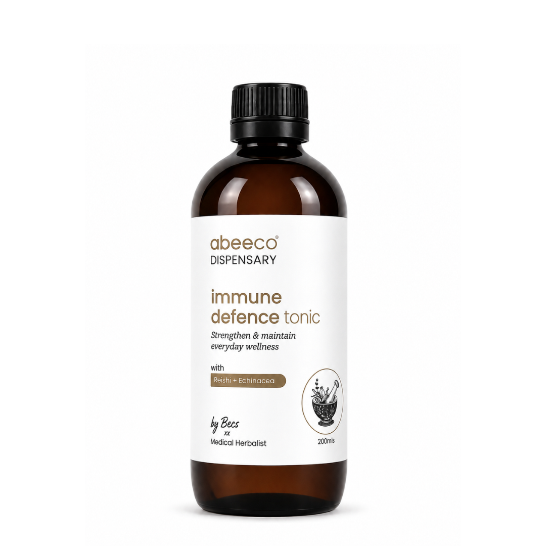 An amber glass bottle of abeeco Dispensary 'immune defence tonic' with a black cap and a white label, set against a plain white background.