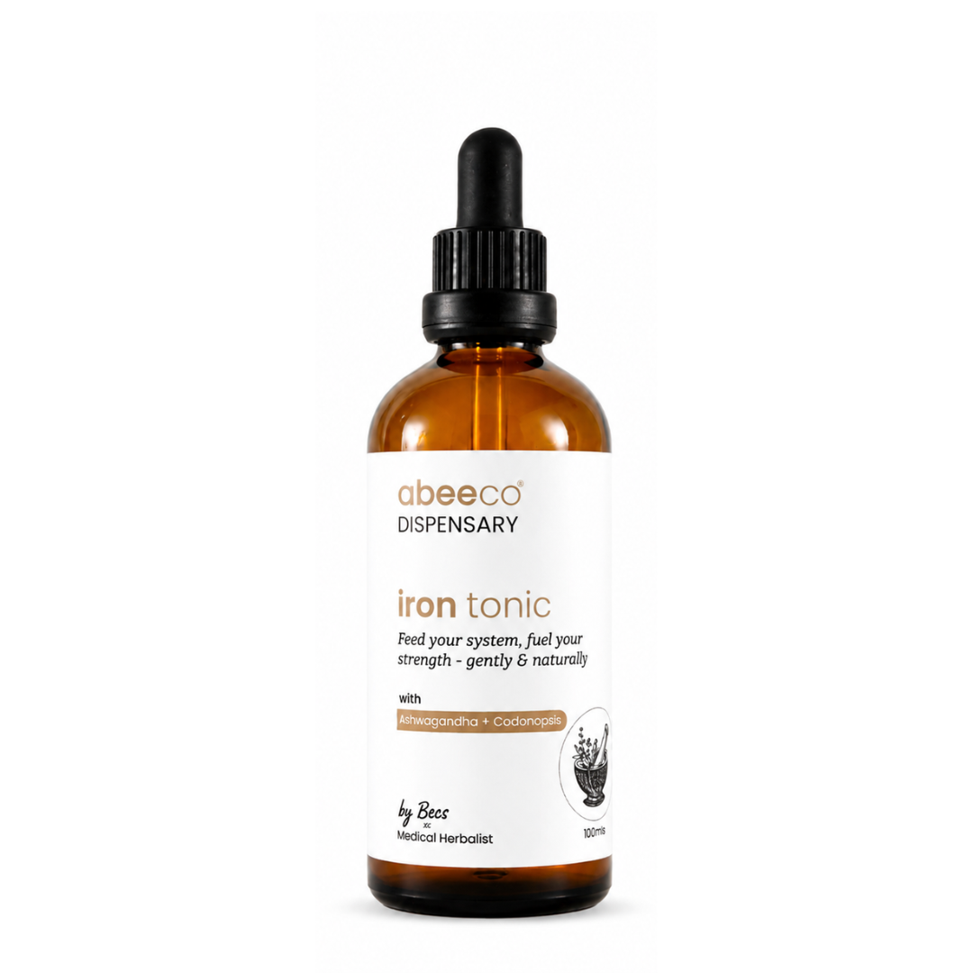 An amber glass dropper bottle of abeeeco Dispensary Iron Tonic with a white label and black dropper cap, centered on a plain white background.