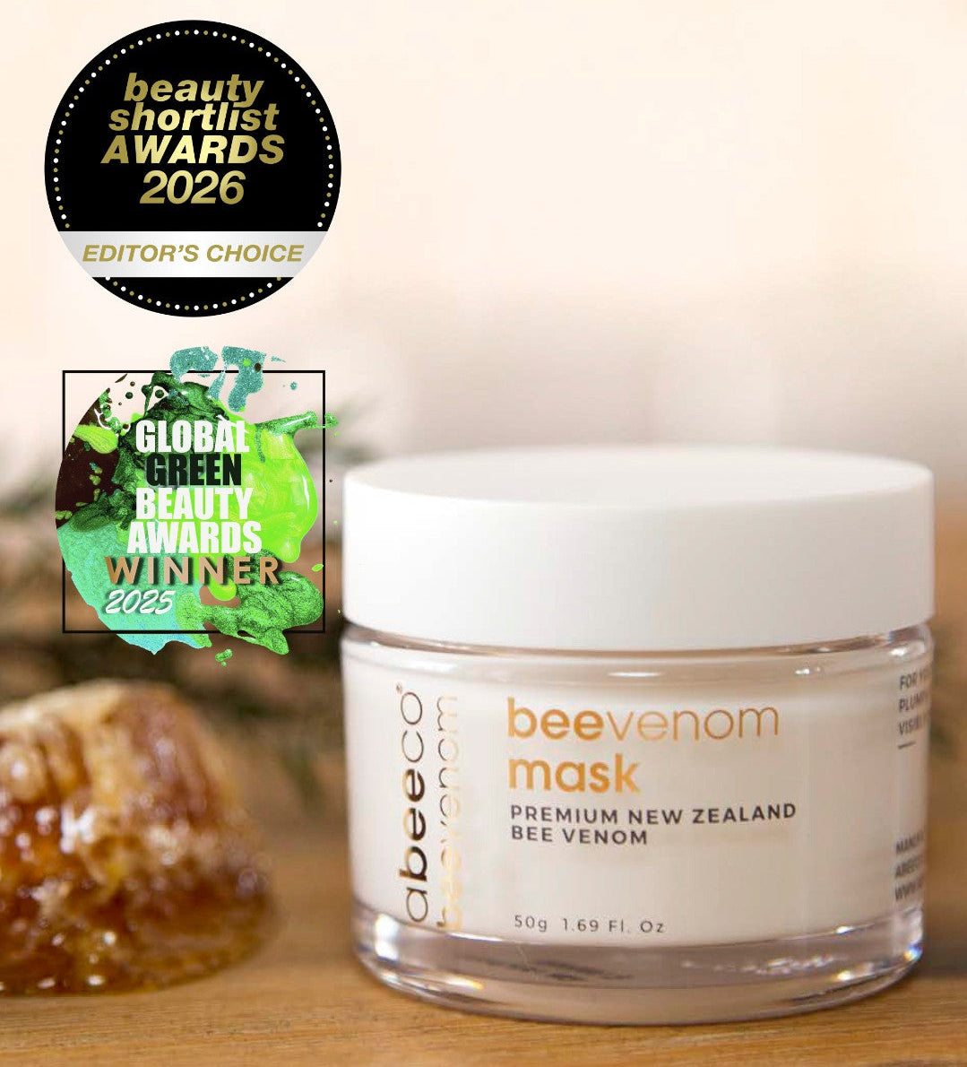 Jar of Abeego bee venom mask with awards on a wooden surface