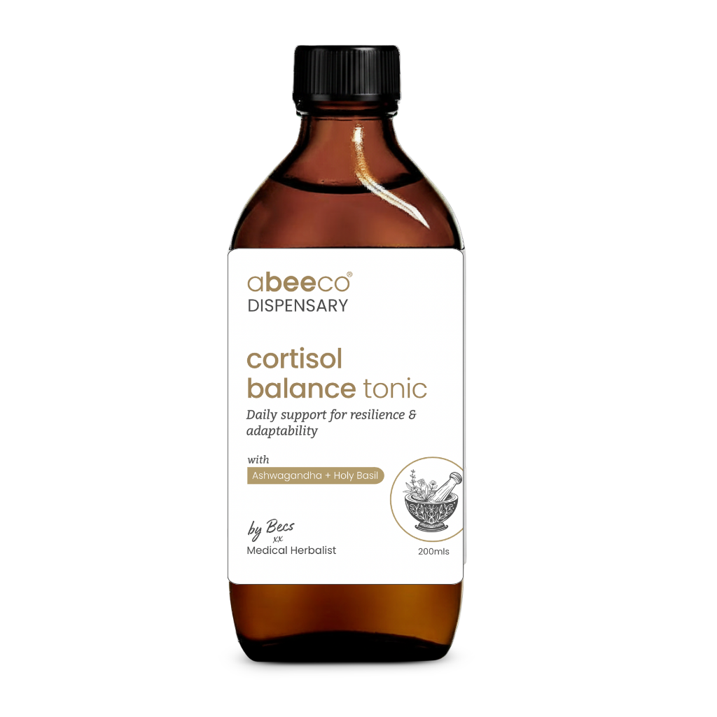 Brown bottle of cortisol balance tonic with a white label on a white background