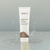 Tube of abeeco brightening cream cleanser on a gray background with water droplets.